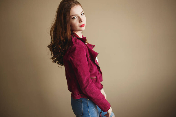 Young hipster woman clothed in magenta jacket. Beautiful eyes, long brown curly hair - 写真・画像