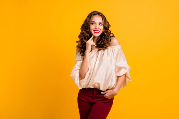 Portrait of her she nice-looking well-groomed attractive stunning fascinating winsome shy cheerful cheery wavy-haired girl touching chin isolated over bright vivid shine yellow background - Foto, Imagen