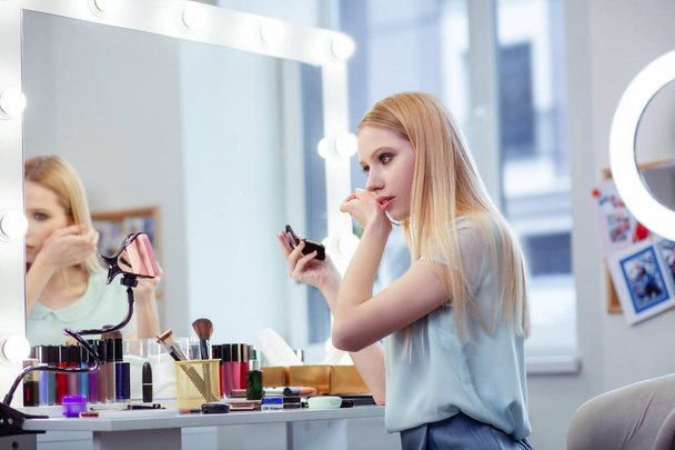 Good looking young woman showing makeup lesson - Fotó, kép
