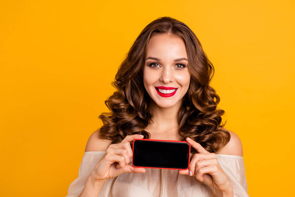Close-up portrait of her she nice-looking attractive lovely winsome cheerful cheery wavy-haired lady advice promo new 5g app internet online advert isolated over bright vivid shine yellow background - Foto, afbeelding