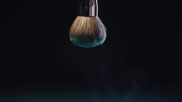 slow motion shoot of green holi paint falling slowly down from cosmetic brush - Footage, Video