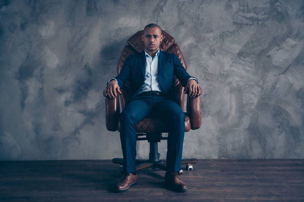 Portrait serious focused chairman entrepreneur manager ceo boss short hair bald sit brown furniture dream dreamy leader leadership dressed fashionable blazers trousers shoes isolated dark background - Foto, imagen