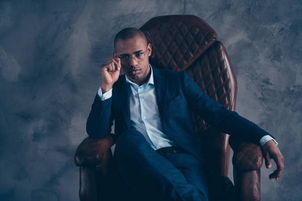 Close up photo serious collar entrepreneur concept manager boss chairman confident cool bald feel focused concentrated  touch  modern blazer sit brown furniture isolated grey background - 写真・画像