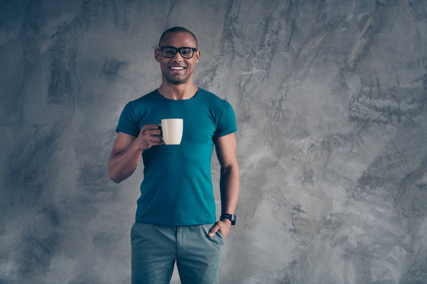 Close up photo amazing yell he him his dark skin macho handsome hand arm hold raise hot beverage office working day workaholic great mood wear specs casual blue t-shirt isolated grey background - Foto, Imagem