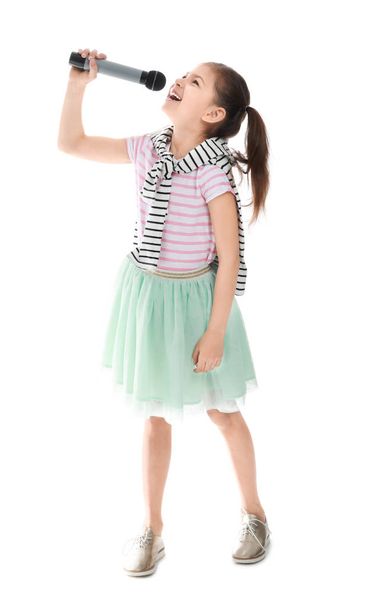 Little girl with microphone singing against white background - Photo, Image