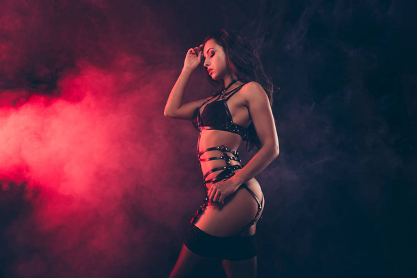 Profile side view portrait of nice lovely stunning charming dreamy attractive sportive shape wavy-haired lady wearing swordbelt posing teasing isolated on black red light background - Φωτογραφία, εικόνα