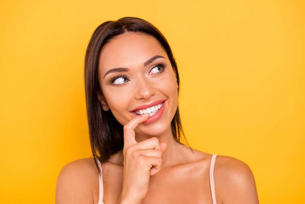 Close up photo beautiful amazing she her lady mouth white ideal teeth bite index finger look up empty space tricky wear casual pastel tank-top outfit clothes isolated yellow bright vibrant background - Foto, imagen