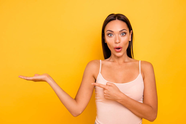 Close up photo amazing beautiful she her lady hold open hand arm finger indicate empty space advise black friday prices wear casual pastel tank-top outfit clothes isolated yellow bright background - Photo, Image