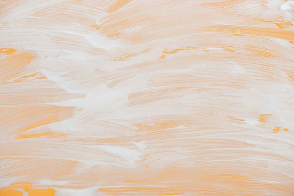 glass covered with white foam on orange background - Foto, imagen