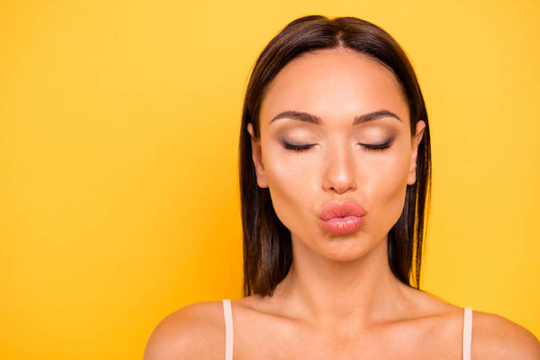 Close up photo amazing beautiful she her lady send air kisses boyfriend show ideal tempting big operated lips mouth wear casual pastel tank-top outfit clothes isolated yellow bright background - Foto, immagini