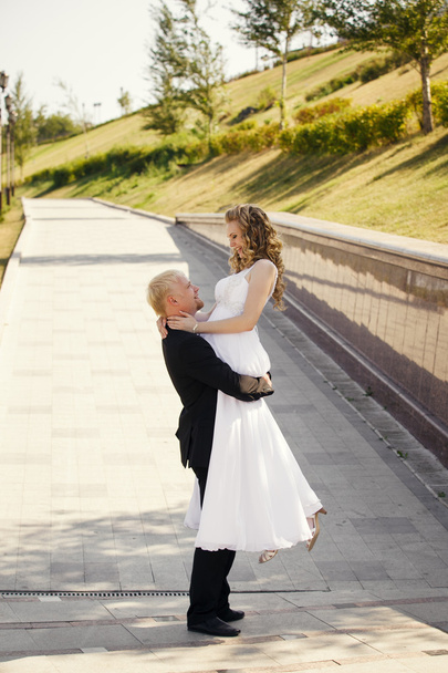 Happy bride and groom in a park - Zdjęcie, obraz
