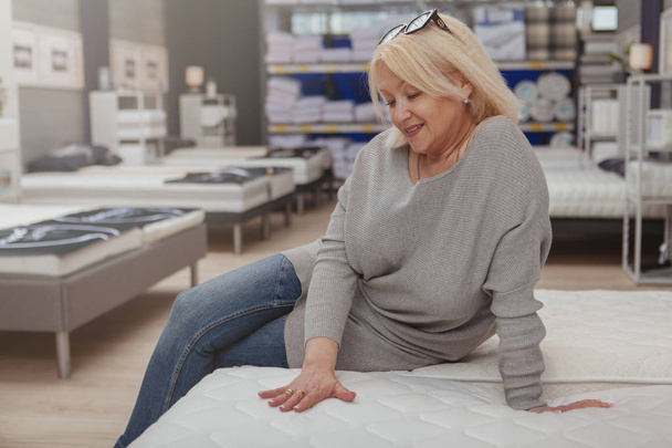 Mature woman shopping at furnishings store - Foto, afbeelding