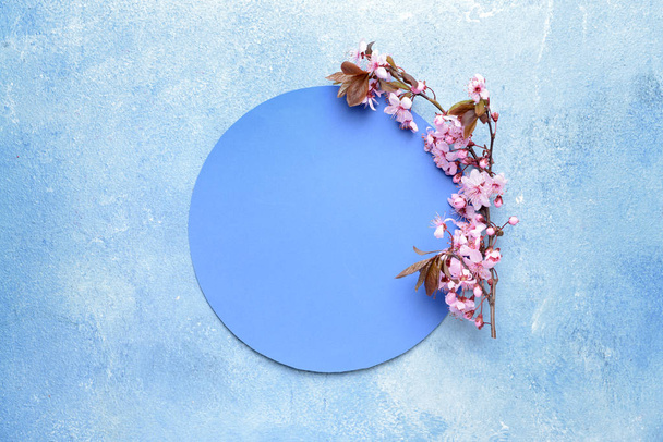 Paper circle and beautiful blossoming branches on color background - Photo, Image