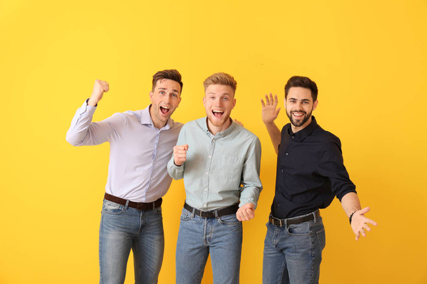 Happy young men on color background - Foto, Imagem