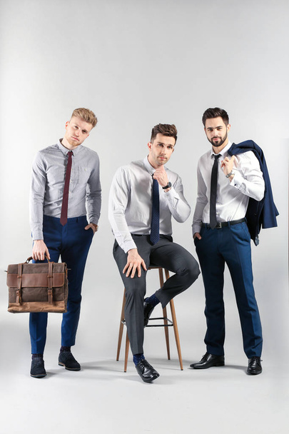Fashionable young men on light background - Foto, immagini