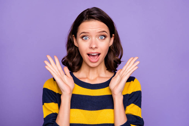 Close up photo beautiful amazing she her lady arms raised ecstatic astonished hear listen great good news unexpected lucky big eyes wear blue yellow striped pullover isolated violet purple background - Foto, imagen