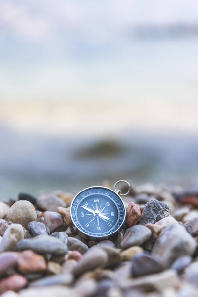 Navigation concept: Compass is lying on the beach near the sea - 写真・画像
