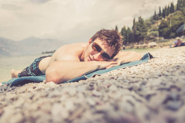 Enjoying the holiday on the beach. Handsome with sunglasses. - Fotografie, Obrázek