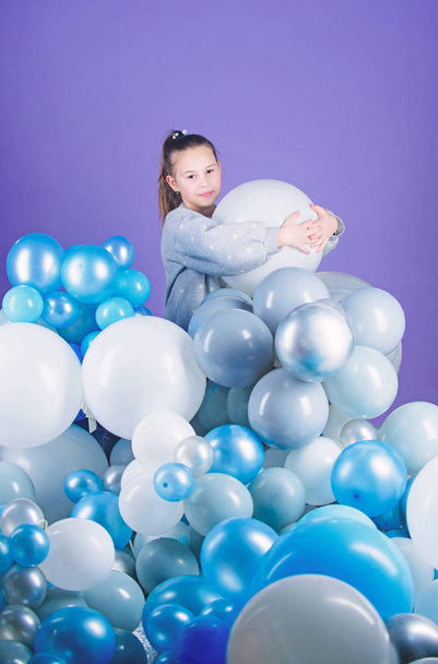 Having fun. Balloons theme party. Girl play with air balloons. Birthday party. Childrens day. Carefree childhood. All those balloons for me. Obsessed with air balloons. Happiness positive emotions - Фото, изображение