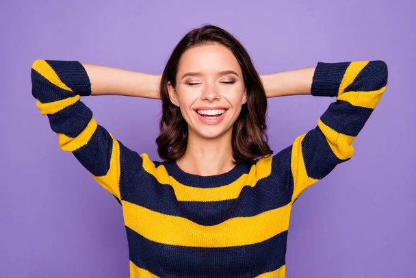 Close up photo beautiful amazing funky she her lady hold hands arms behind head eyes closed napping relaxing refreshment toothy wear blue yellow striped pullover isolated violet purple background - Foto, imagen