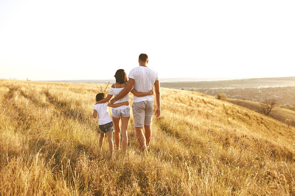 Happy family walking in nature at sunset in summer. - Foto, immagini
