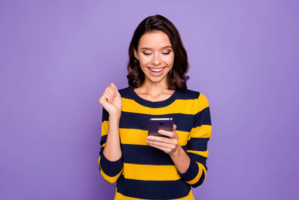 Close up photo beautiful amazing she her lady hands hold telephone reader news information amazed excited big surprise shock omg wow wear blue yellow striped pullover isolated violet purple background - Фото, зображення