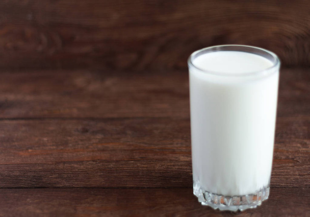 a glass of cow's milk on a wooden background - Fotoğraf, Görsel