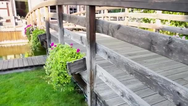 4k videó szép régi fa híd virágcserepek mint vízcsatorna a kis európai városban nyáron - Felvétel, videó