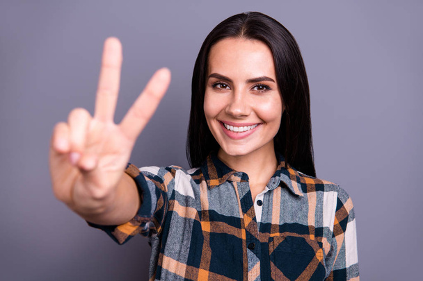 Close-up portrait of her she nice-looking winsome sweet lovely attractive cheerful positive straight-haired lady wearing checked plaid giving v-sign isolated over gray pastel background - Foto, imagen