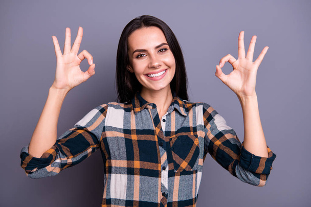 Portrait of her she nice-looking lovely pretty winsome attractive cheerful cheery positive straight-haired lady wearing checked plaid showing two ok-sign isolated over gray pastel background - Fotoğraf, Görsel