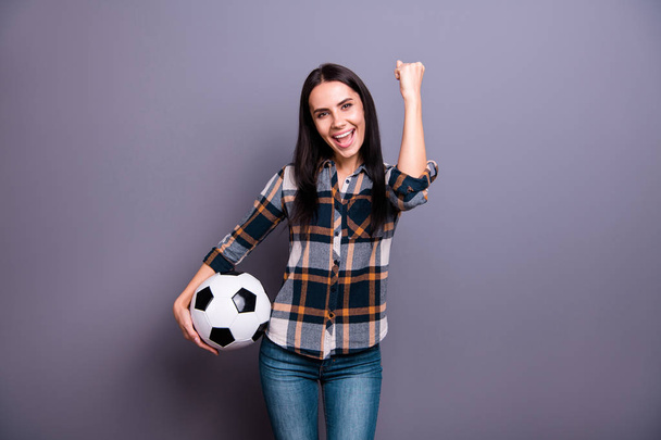 Close up photo amazing beautiful she her lady hold hand arm raised air leather football soccer ball yelling triumphing crazy wear casual jeans denim checkered plaid shirt isolated grey background - Φωτογραφία, εικόνα