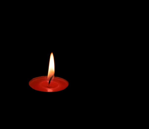 vela vermelha queimando em um espaço escuro
 - Foto, Imagem