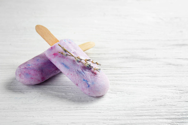 Tasty lavender ice cream on white wooden background - Photo, Image