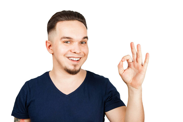 Adult funny guy smiles and show sign ok. Isolated on white background - Фото, изображение