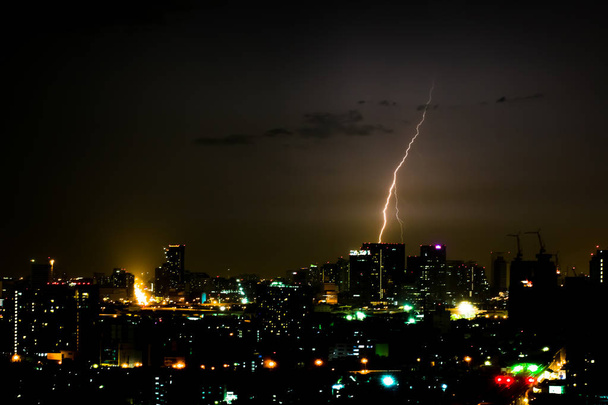 Dramatic thunder storm lightning bolt on the horizontal sky and city scape - Photo, Image