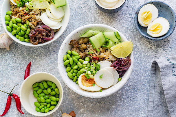 Vegetarian dishes with marinated egg and edamame beans in bowls  - 写真・画像
