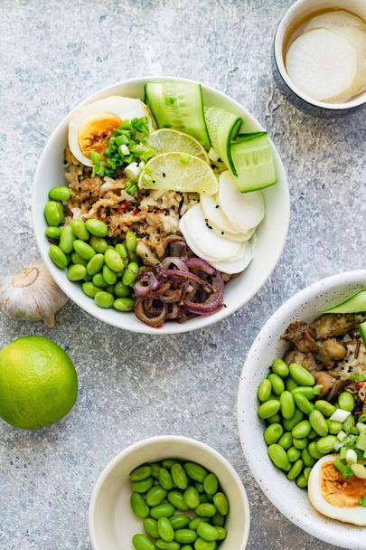 Vegetarian dishes with marinated egg and edamame beans in bowls  - Foto, afbeelding
