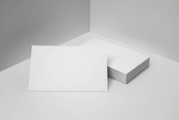 Blank business cards on white background for mockup. - Фото, изображение