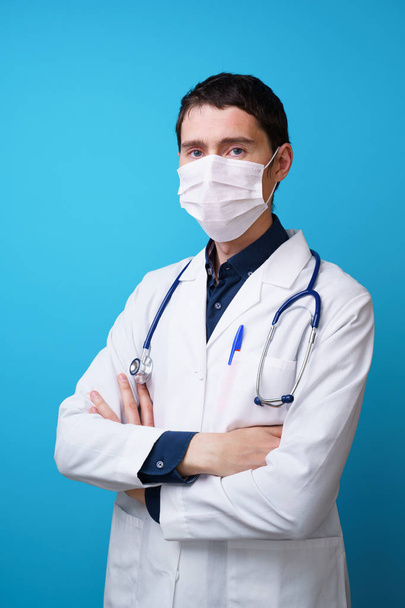 Portrait of a doctor with a stethoscope on the neck and mask on his face. - Photo, Image
