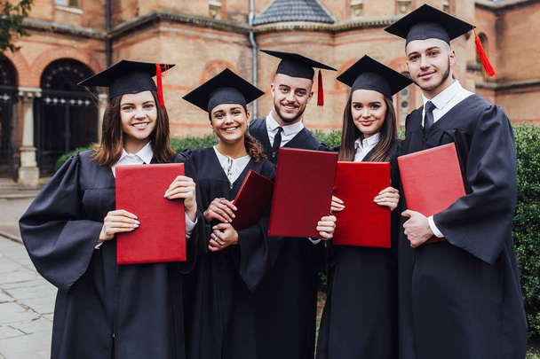 Students with diplomas, focus on foreground - Foto, Imagem