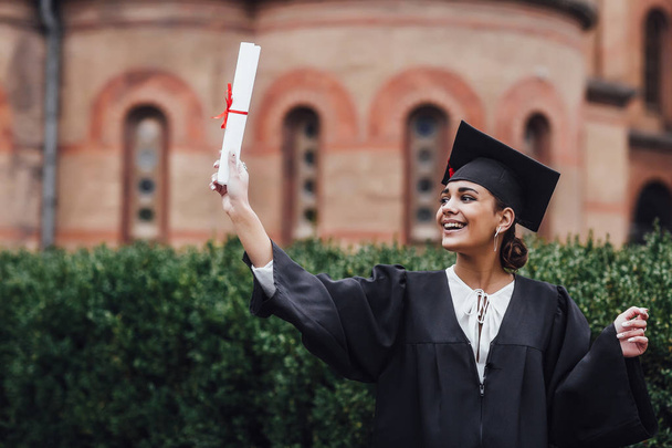 Happy graduated student woman, focus on foreground - Fotó, kép