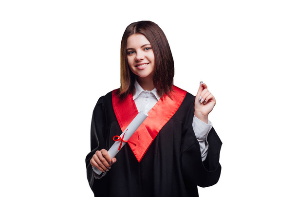 Young brunette graduate woman in mantle isolated on white background - Foto, immagini