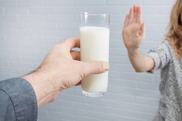 hand rejecting the glass of milk, intolerance to dairy - Photo, Image
