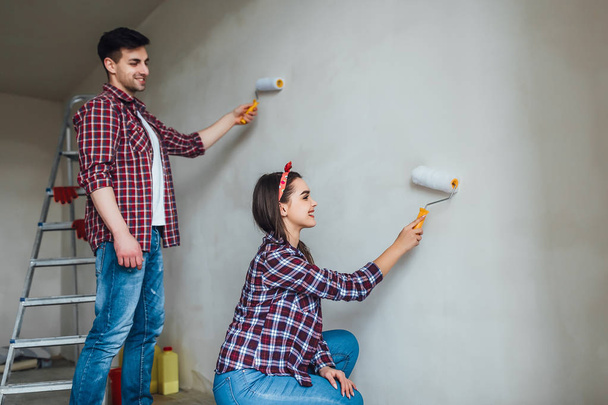 Portrait of couple doing redecoration in apartment, selective focus - 写真・画像