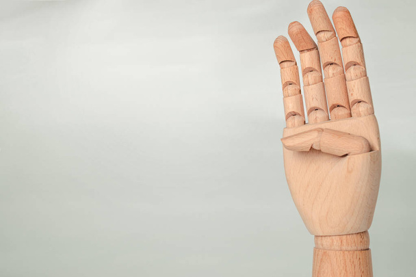A wooden orthopedic hand on white background. - Foto, afbeelding