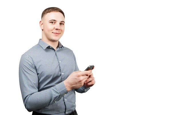White young guy looking at his smartphone. Isolated on white background. - 写真・画像