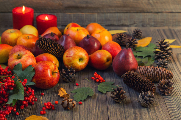 Autumn food background with apples, pine cones, spices, berries and fallen leaves with copy space for text. Autumn food backdrop. Selective focus. - Photo, image