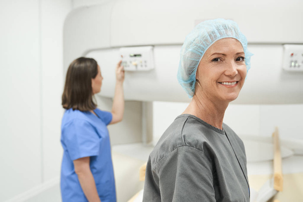 Portrait Of Happy Mature Woman Smiling As Patient In Clinic - Fotó, kép
