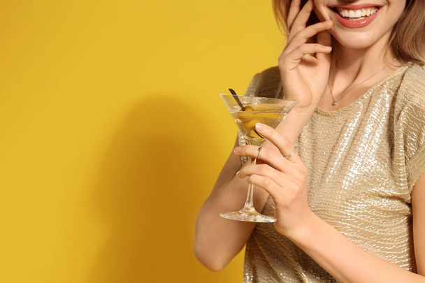 Young woman with glass of martini cocktail on color background, closeup. Space for text - Zdjęcie, obraz