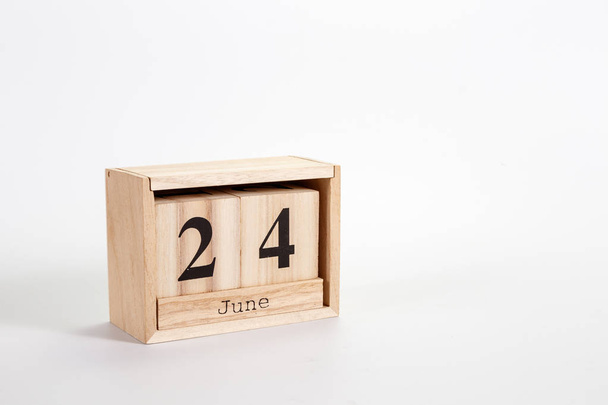 Wooden calendar June 24 on a white background - Foto, afbeelding
